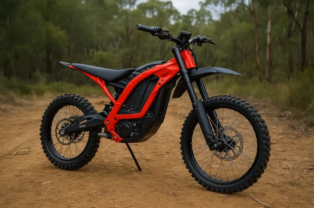 Surron Komodo electric dirt bike on surrounded by trees.